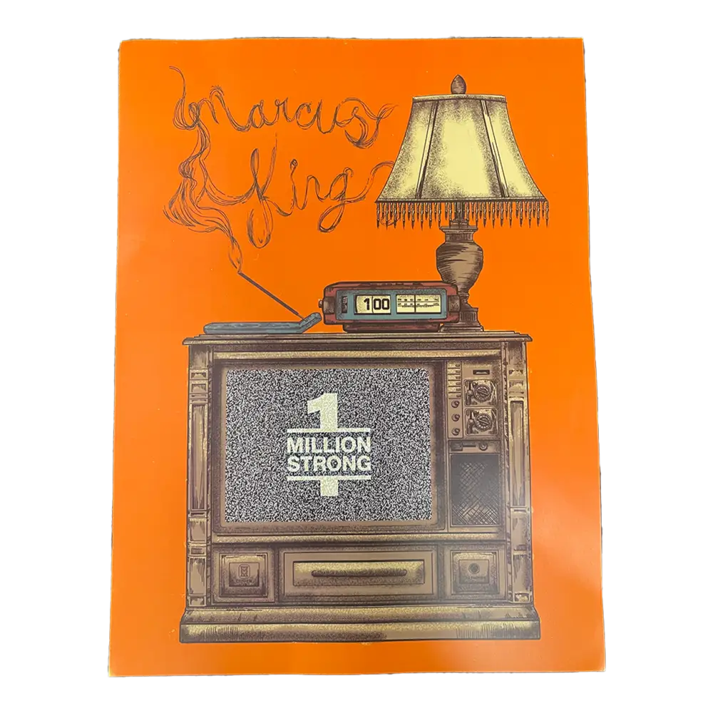 Vintage television set with a lamp on top and ’Million Strong’ displayed on its screen.