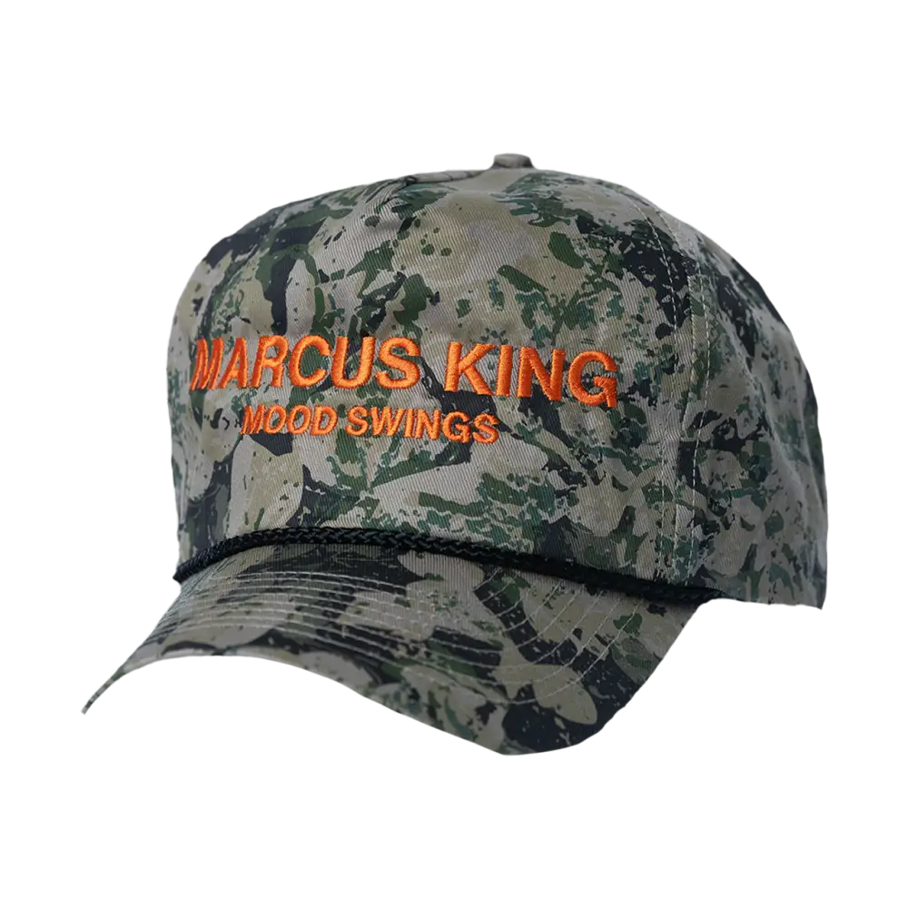 Camouflage baseball cap with orange text reading ’MARCUS KING MOOD SWINGS’.