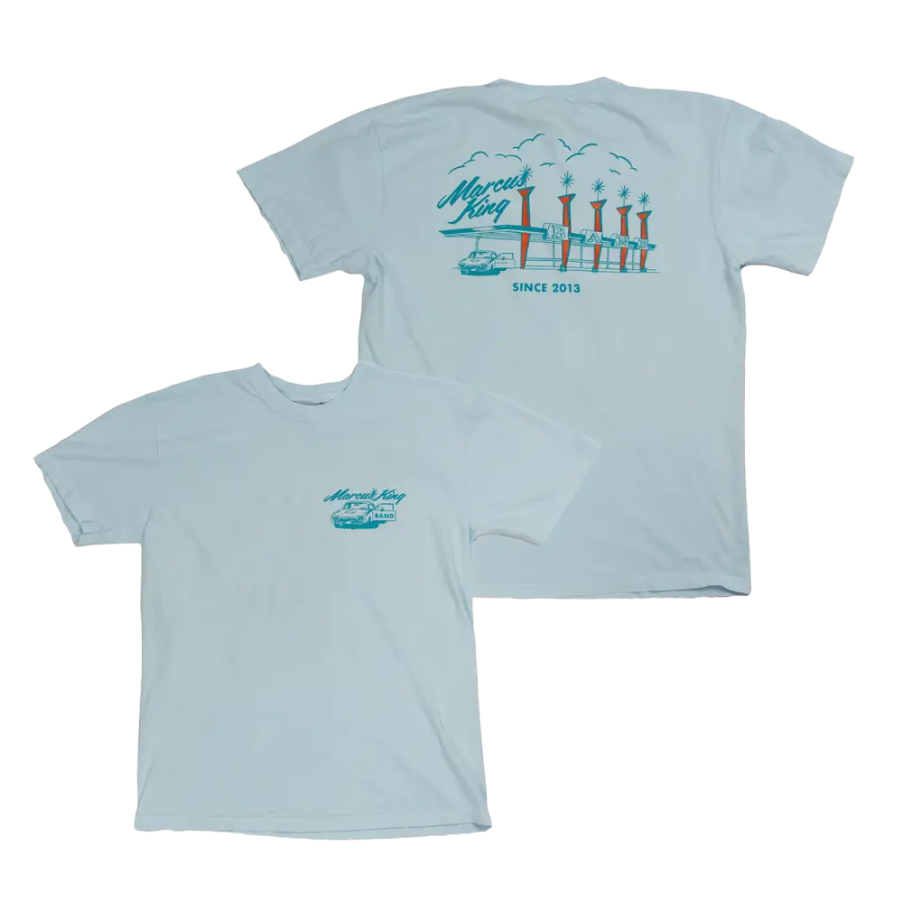 Light blue t-shirt with a coastal-themed graphic design on the front and back.