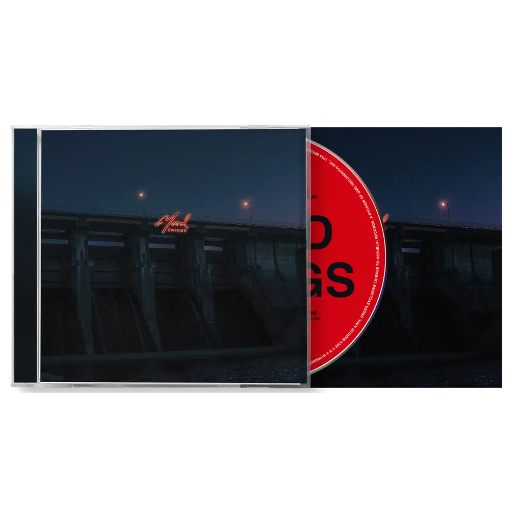 CD album case with a partially visible red disc inside.