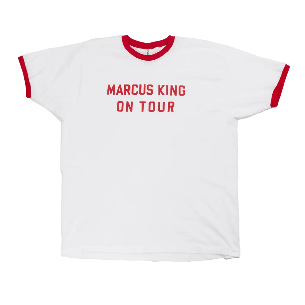 White t-shirt with red trim and ’MARCUS KING ON TOUR’ printed in red letters.