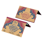 Rolling papers branded as ’Purely King’ with decorative blue flourishes on a tan background.