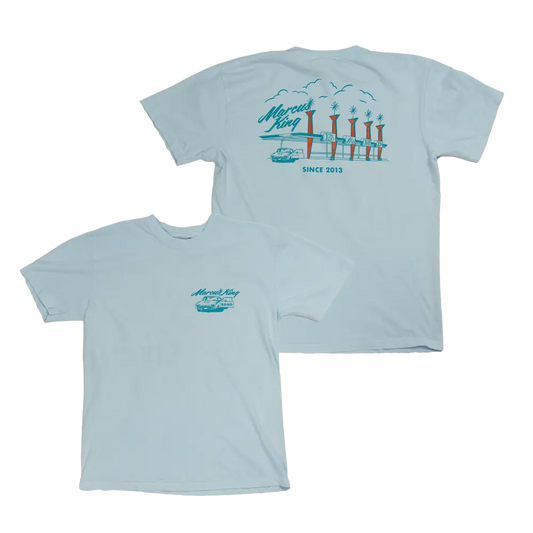 Light blue t-shirt with a coastal-themed graphic design on the front and back.