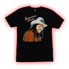 Black t-shirt featuring a portrait of a smiling person wearing a cowboy hat and orange shirt.