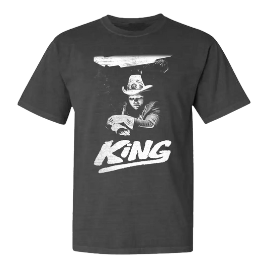 Dark gray t-shirt featuring a black and white graphic design of a cowboy figure with the word ’KING’ below.