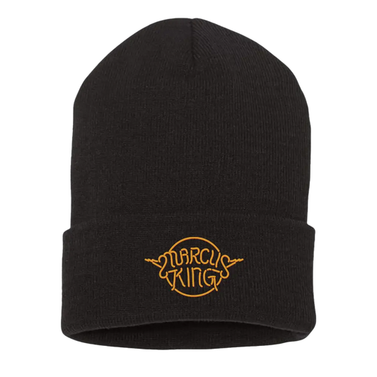 Black knit beanie with a yellow embroidered logo reading ’Marcus King’.