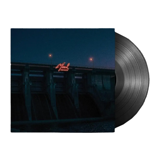 Vinyl record album with a nighttime urban scene on the cover.