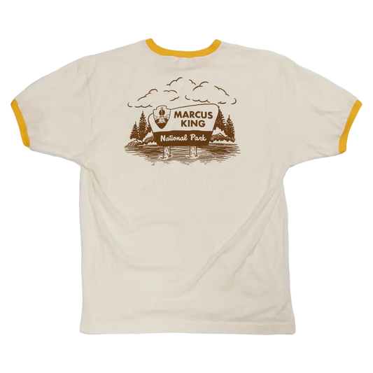 T-shirt with a national park-themed graphic design featuring trees, mountains, and the text ’Marcus King National Park’.